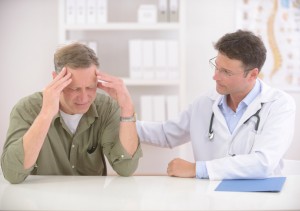 Doctor comforting mature male patient